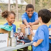 children collecting canned food for a food drive