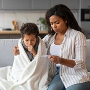 worried mom taking child's temperature