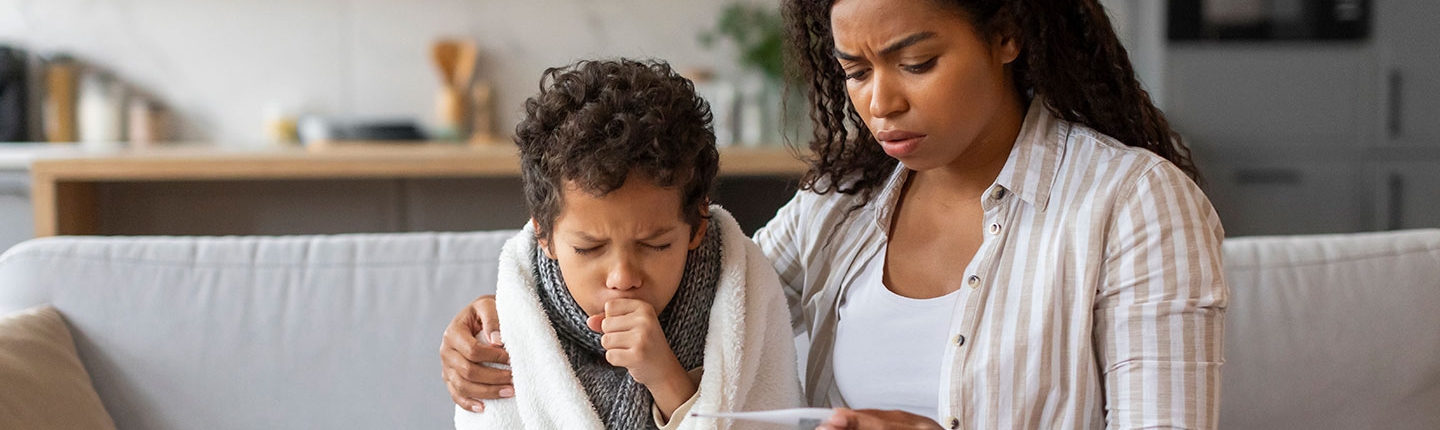 worried mom taking child's temperature