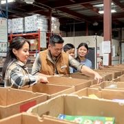 Family packing boxes at a food bank