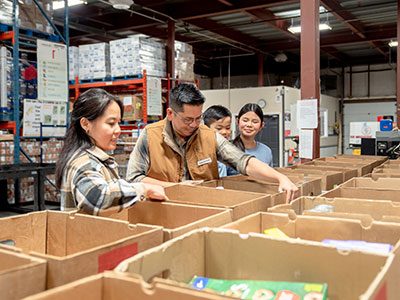 Family packing boxes at a food bank