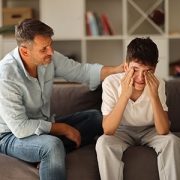 father comforting crying son