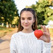 Girl holding plastic heart