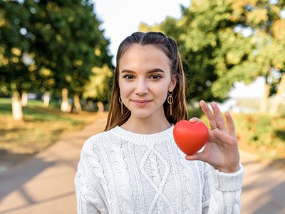 Girl holding plastic heart