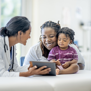 Provider with mother and child in exam room