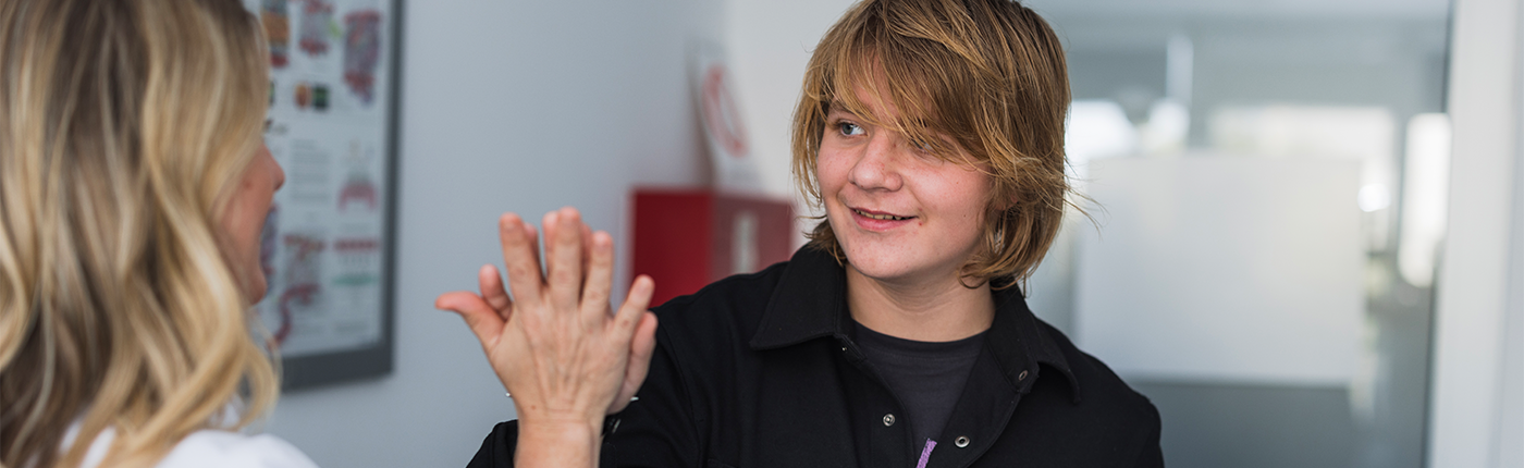 Teen high fiving healthcare provider