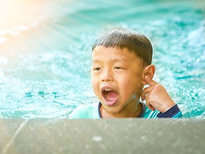 Child touching their ear