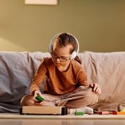 Boy sitting on couch with headphones on
