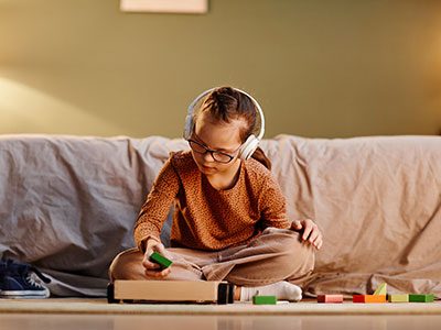 Boy sitting on couch with headphones on