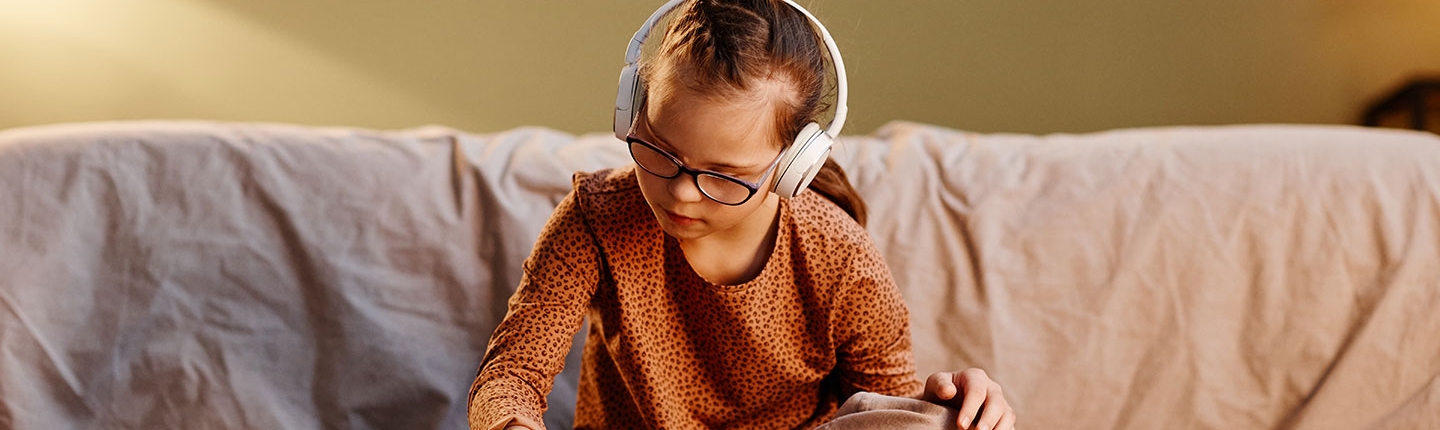 Boy sitting on couch with headphones on