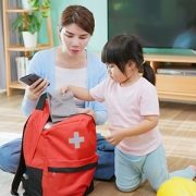 mother and daughter packing emergency kit