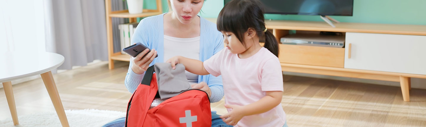 mother and daughter packing emergency kit
