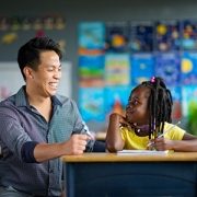 Teacher helping a student with school work