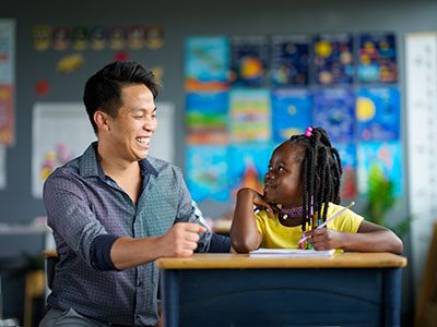 Teacher helping a student with school work