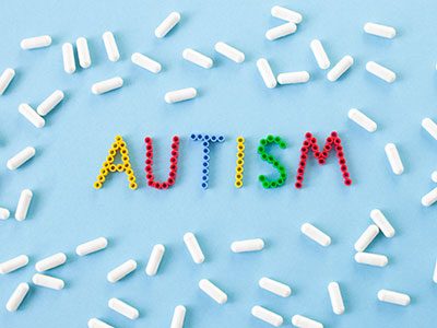 the word autism surrounded by pills