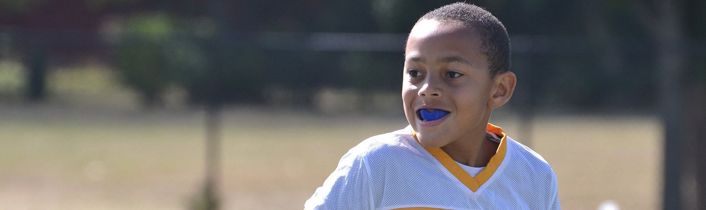 boy with a mouthguard play sports