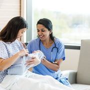 A new mother holds her baby in the hospital