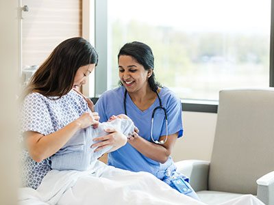 A new mother holds her baby in the hospital