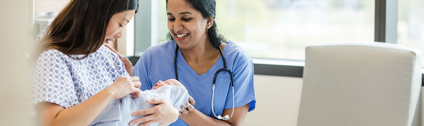 A new mother holds her baby in the hospital