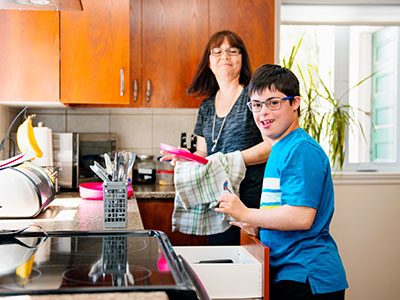 autistic boy doing dishes