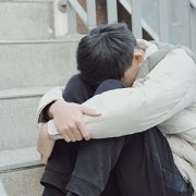 sad boy hugging his legs