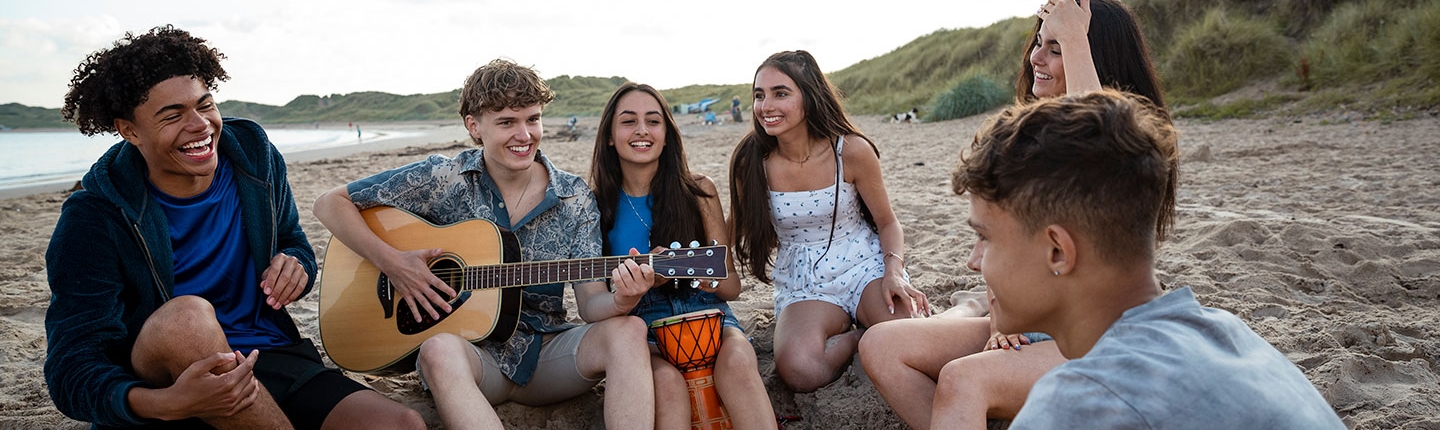 teens hanging out at the beach