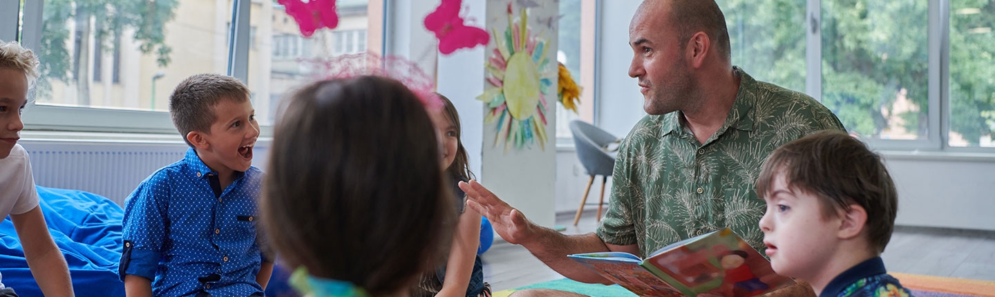 teacher reading a book to children in an elementary school or kindergarten