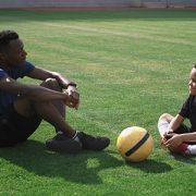 Parent and young athlete talking