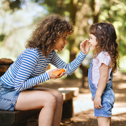 Mother putting sunscreen on child.