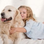 young girl hugging dog