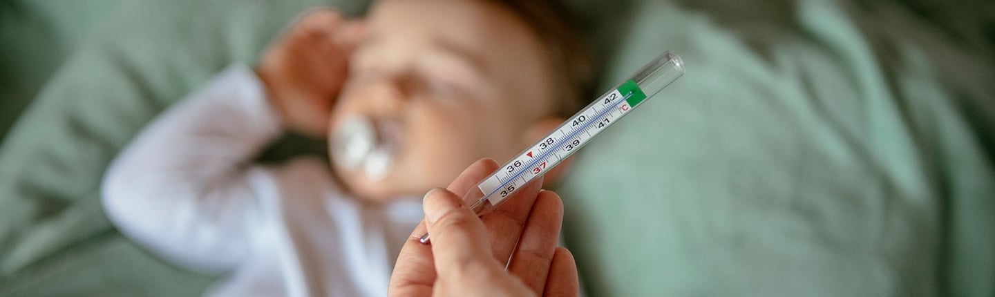 sleeping baby with thermometer