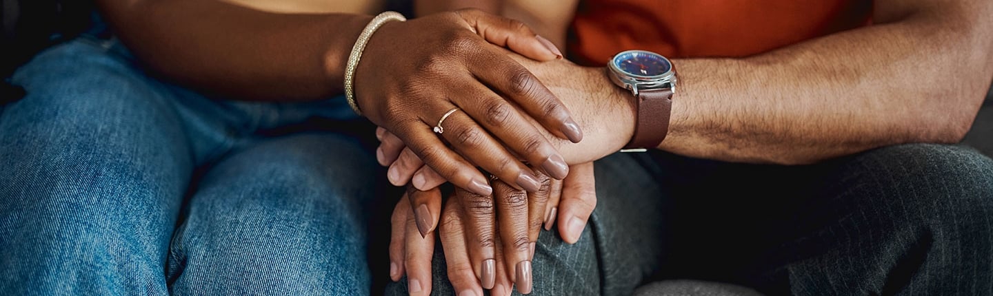 closeup of couple holding hands