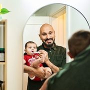 dad brushing baby's teeth