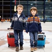 two brothers with suitcases at the airport